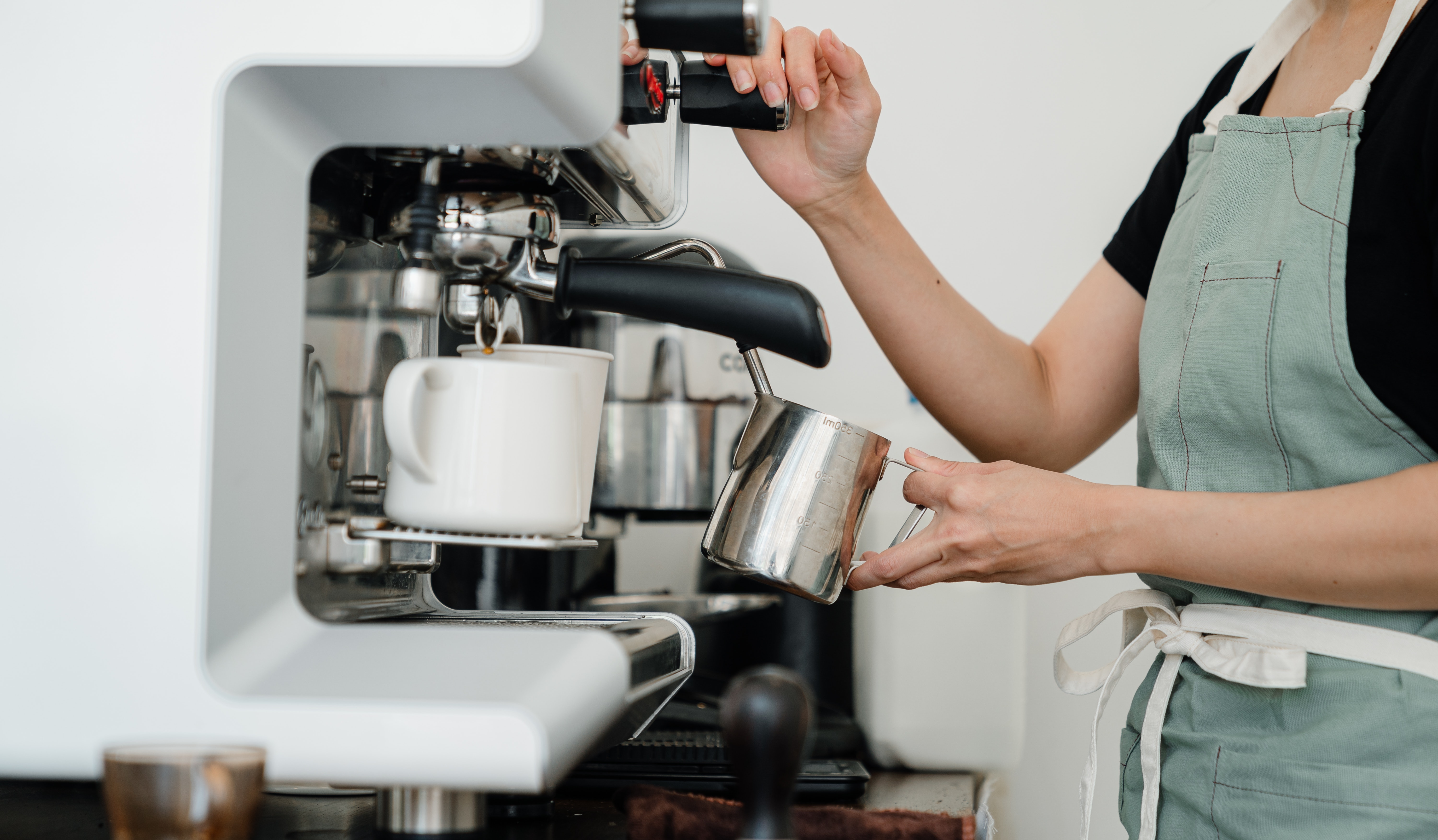 Women working a coffee machine