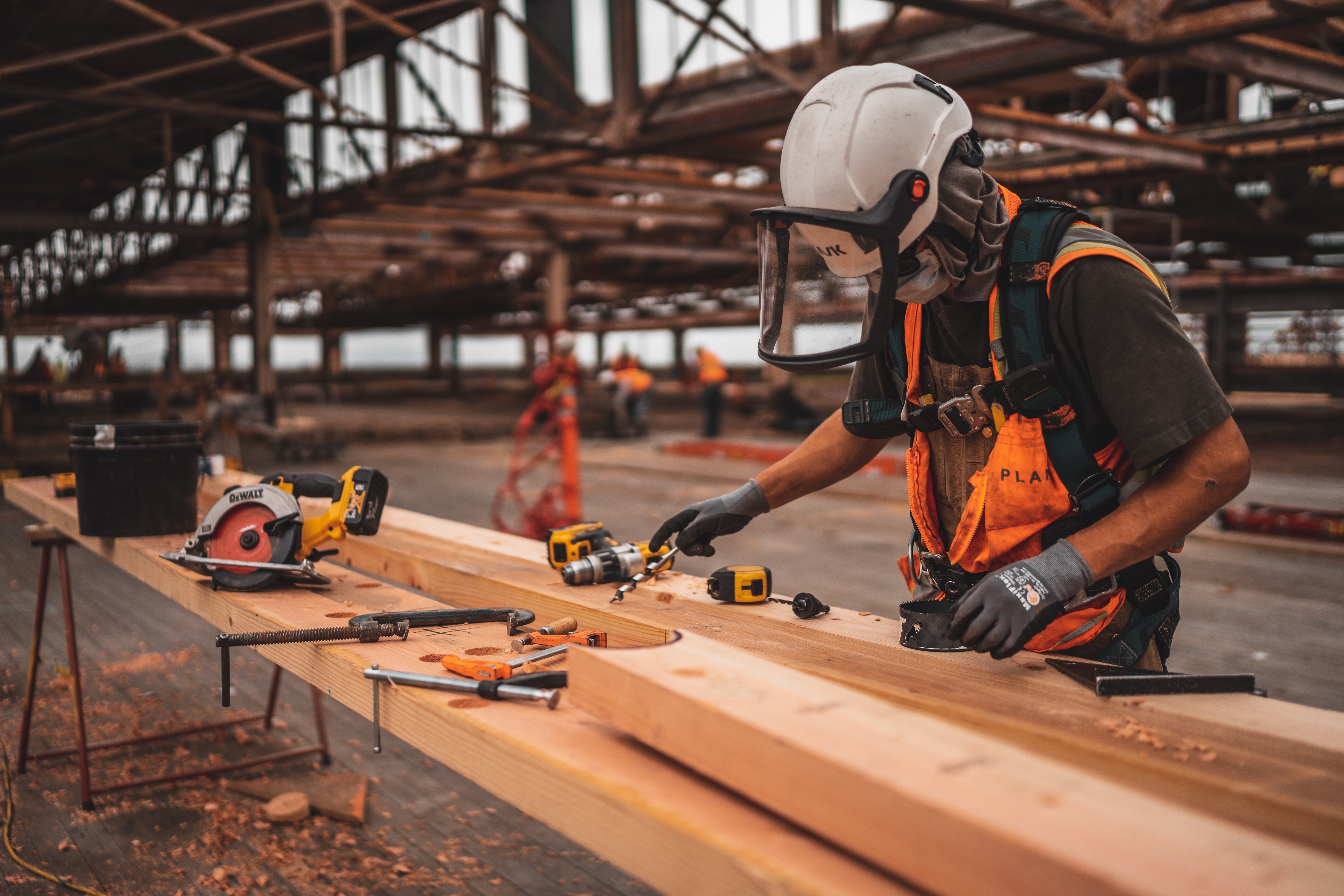 Construction worker cutting wood