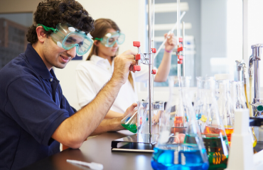 Two scientist working in a lab with lab equipment 