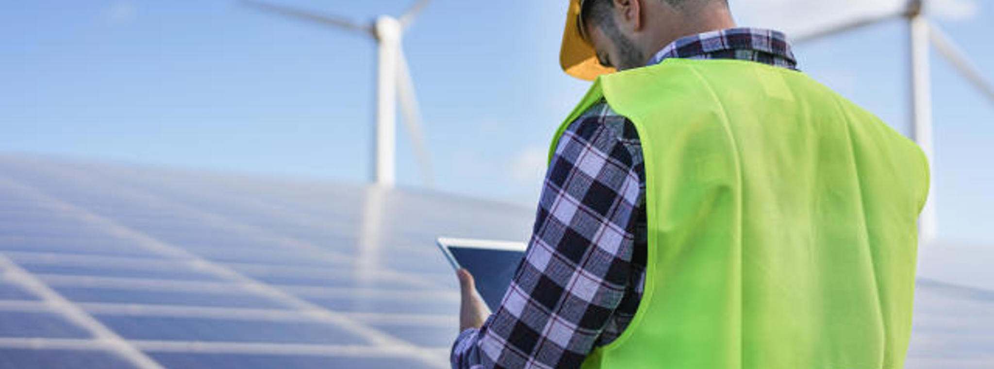 Person working at a wind farm wearing hi vis jacket