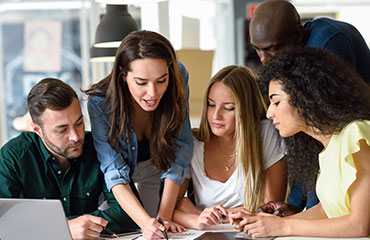 Group of people looking at a document on a table