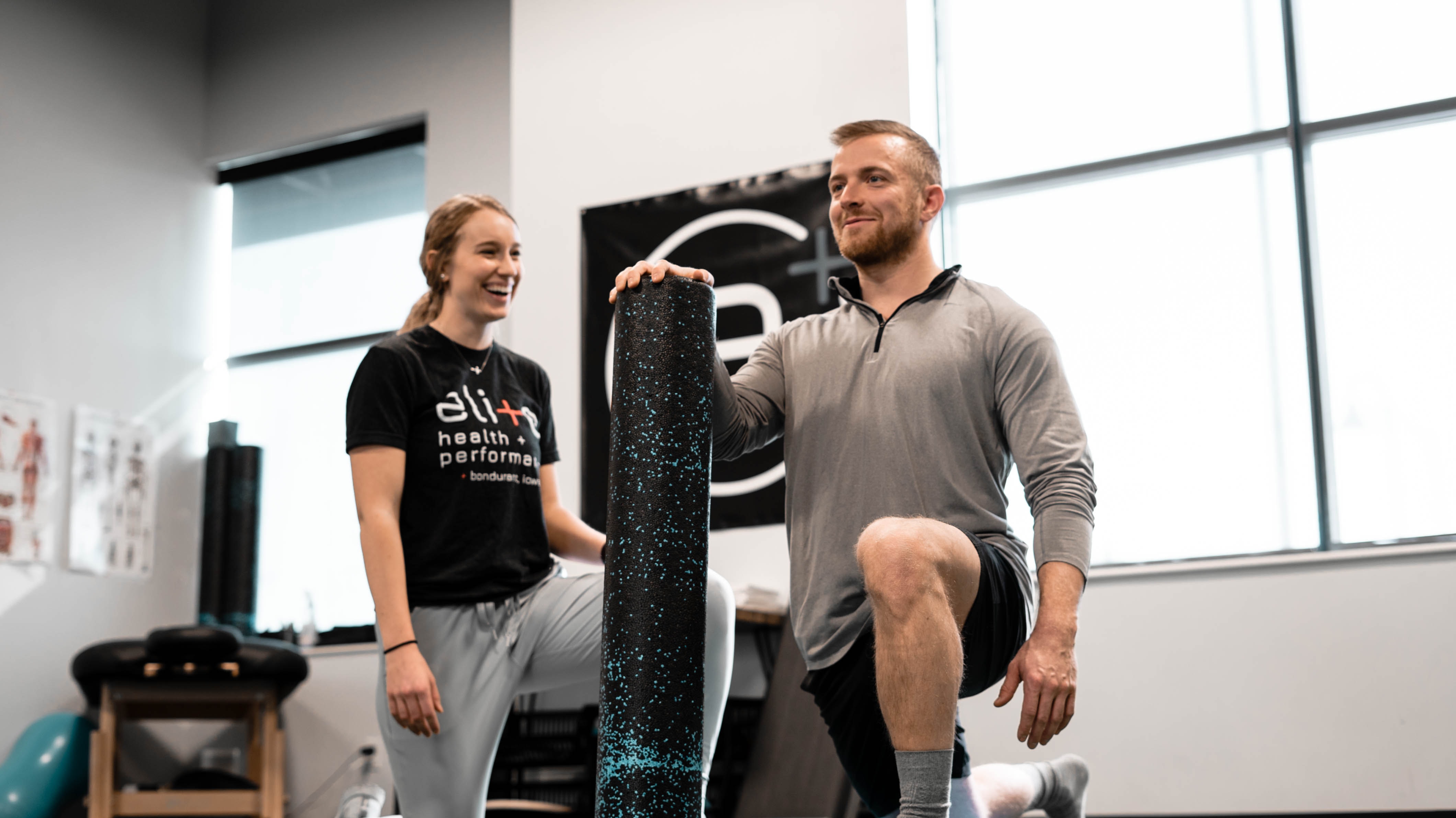 Female physiotherapist helping a man with lunges 