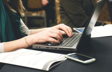 Lady typing on a laptop