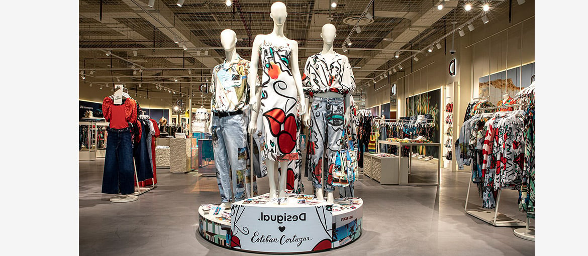 Clothing shop with three manikins wearing patterned clothing