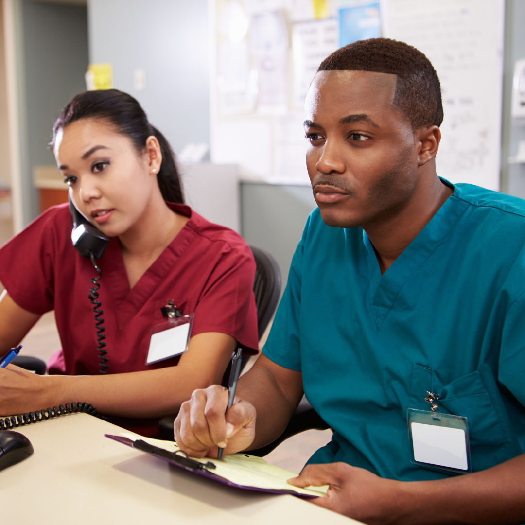 two nurses at a desk