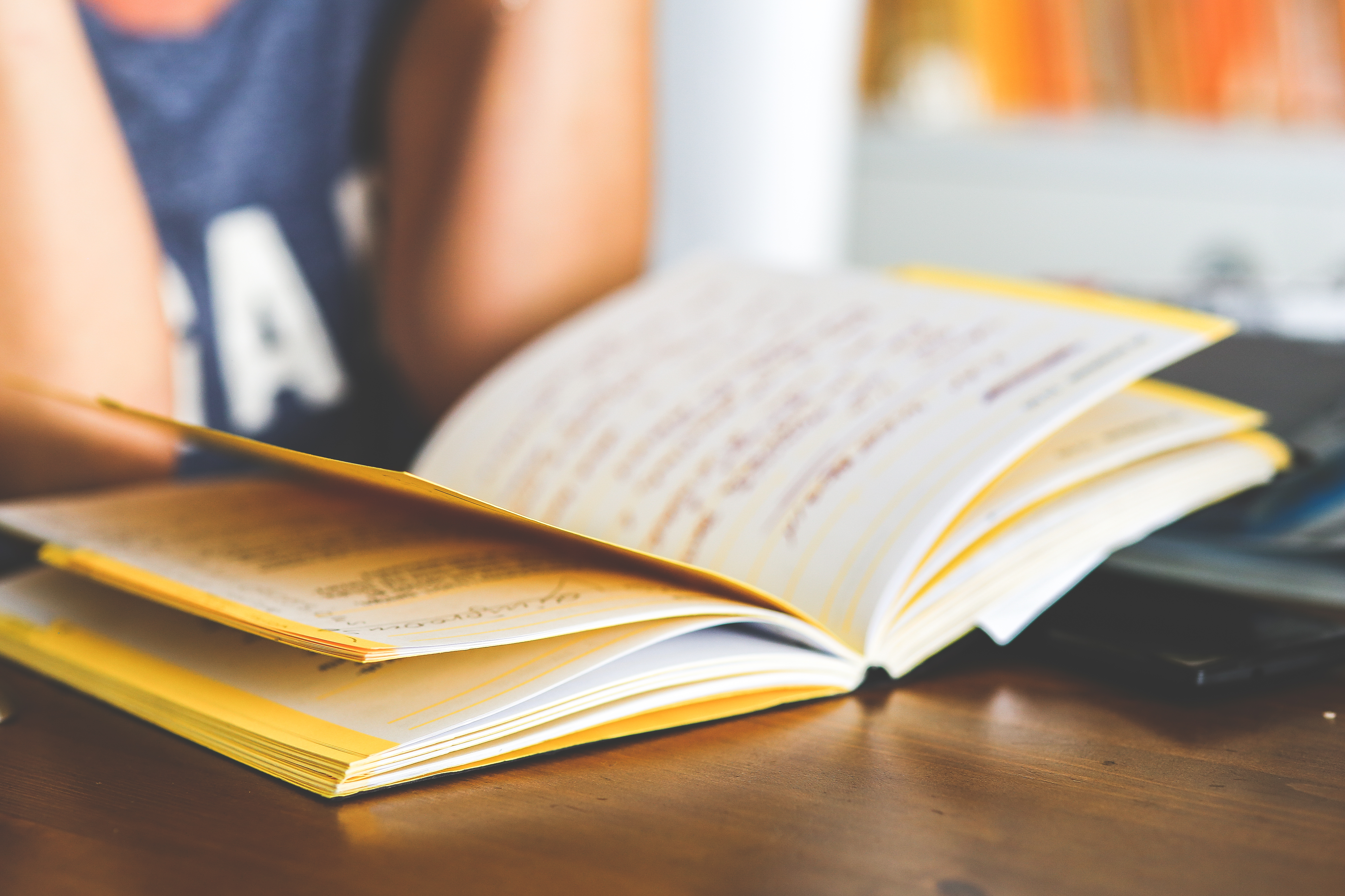 Someone reading a book on a table