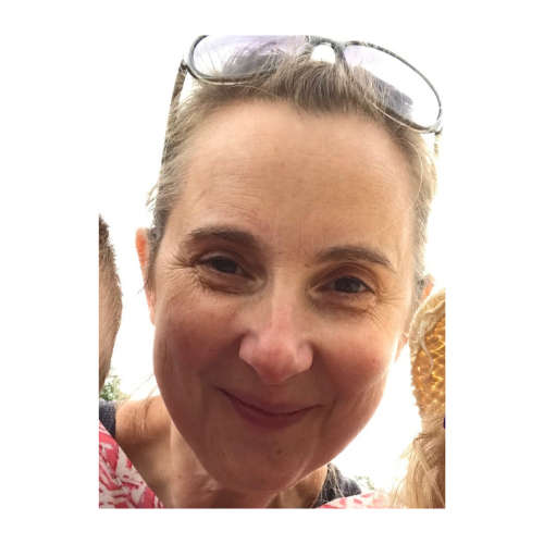 photograph of a woman with glasses on head