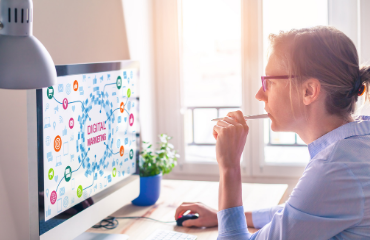 Lady looking at a monitor with a pen 