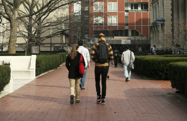 people walking down a red brick path