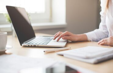 Lady typing on a laptop