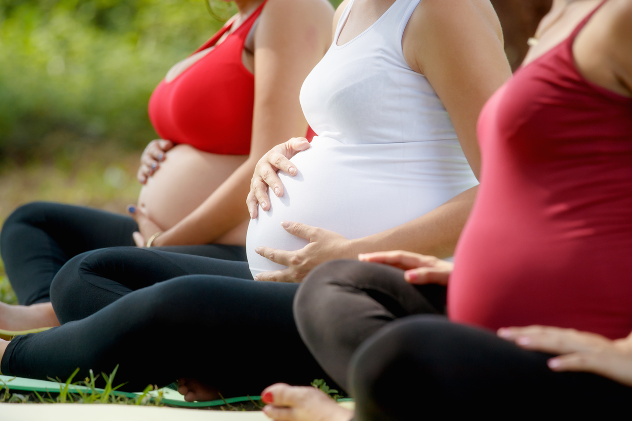 pregnant women sitting cross legged