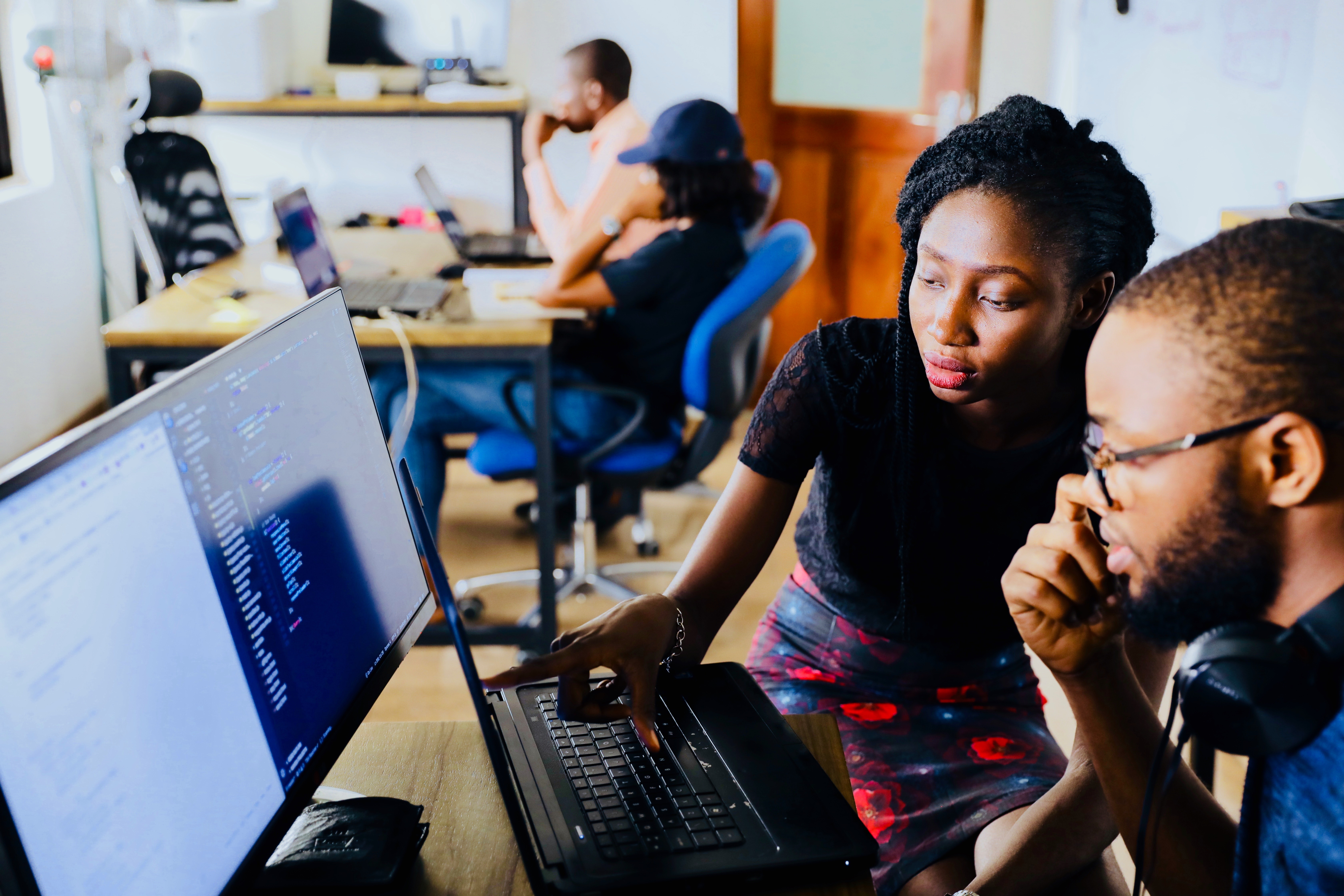 Male and female looking at a laptop with the women pointing at the screen