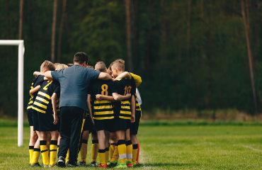Rugby players in yellow and black kit in a huddle