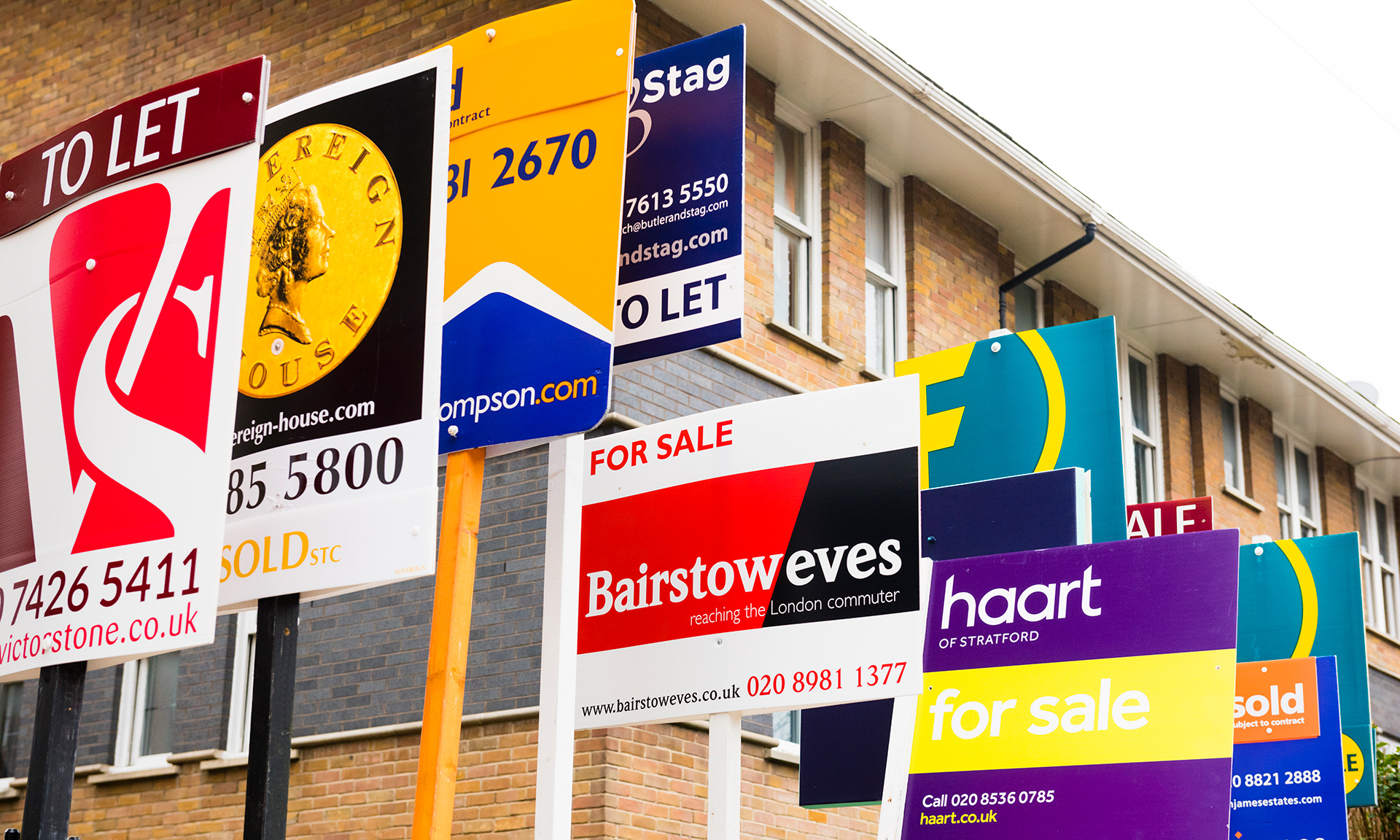 A group of for sale signs close together