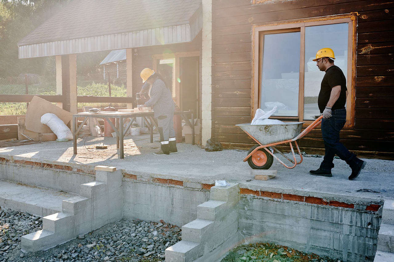 Construction people pushing wheel barrows